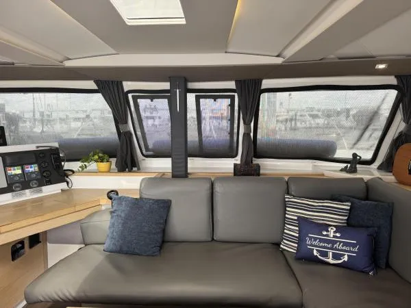 The Flying Tortuga Yacht Photos Pics Interior of 2018 Fountaine Pajot Lucia 40 catamaran with cozy seating and nautical decor.