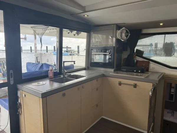 The Flying Tortuga Yacht Photos Pics Modern kitchen interior of 2018 Fountaine Pajot Lucia 40 catamaran with ocean view.