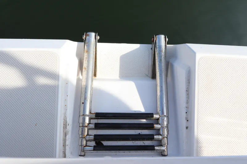  Yacht Photos Pics Stainless steel boat ladder on 2011 Catalina 355 yacht, extending into water.