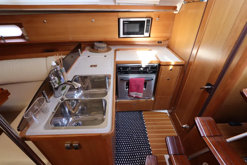  Yacht Photos Pics Luxurious 2011 Catalina 355 yacht kitchen with modern appliances and wooden cabinetry.