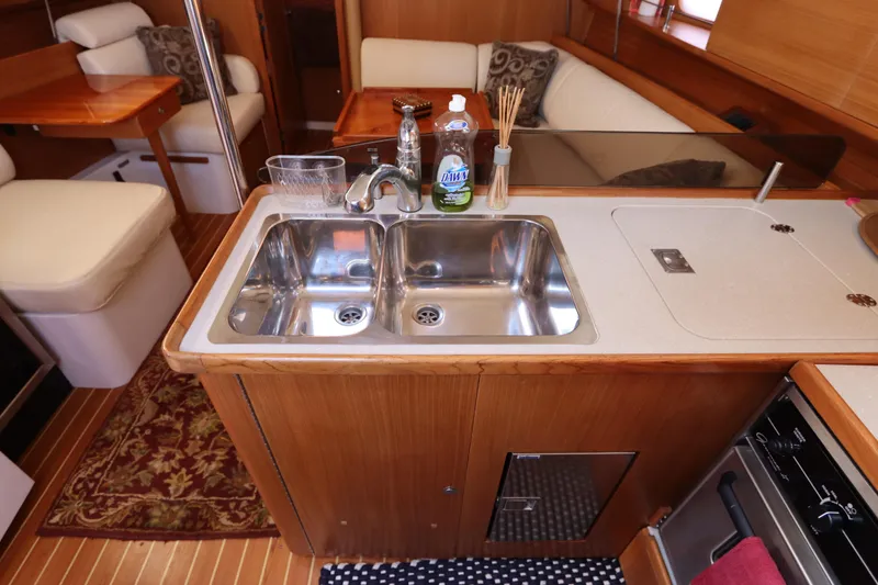  Yacht Photos Pics Interior of 2011 Catalina 355 yacht kitchen with double sink and wooden cabinetry.
