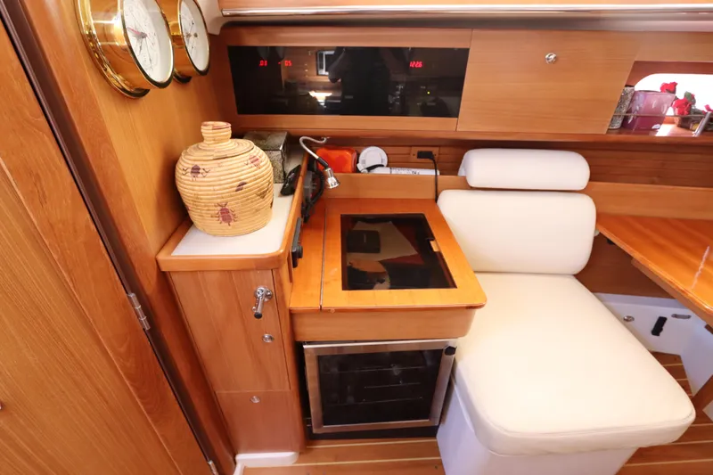  Yacht Photos Pics Cozy interior of 2011 Catalina 355 yacht with wooden cabinetry and comfortable seating.