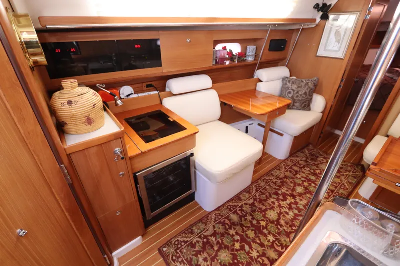  Yacht Photos Pics Interior of 2011 Catalina 355 sailboat with cozy seating and wooden cabinetry.