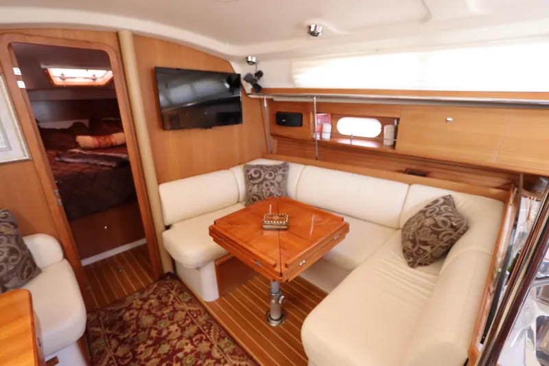  Yacht Photos Pics Luxurious interior of 2011 Catalina 355 sailboat with cozy seating and elegant wood finish.