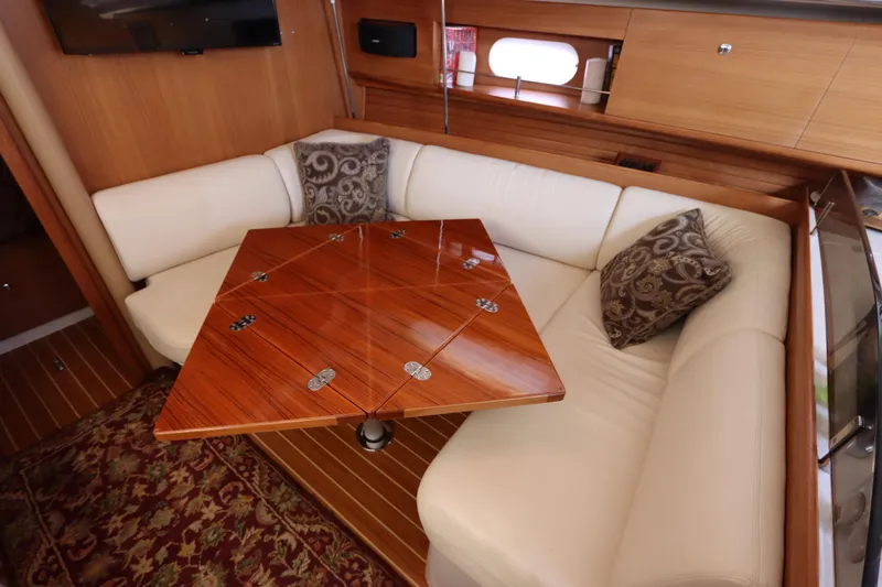  Yacht Photos Pics Luxurious interior of 2011 Catalina 355 yacht with elegant wood table and plush seating.