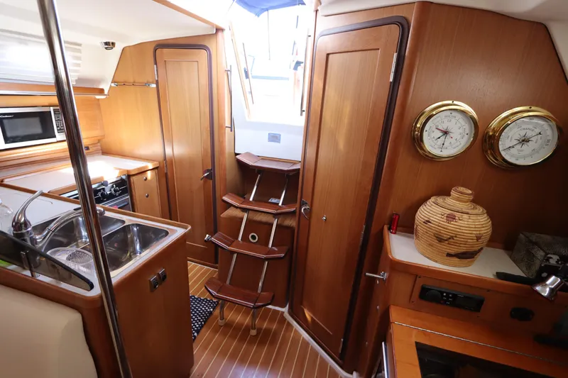  Yacht Photos Pics Interior of 2011 Catalina 355 sailboat with wooden cabinetry and nautical instruments.