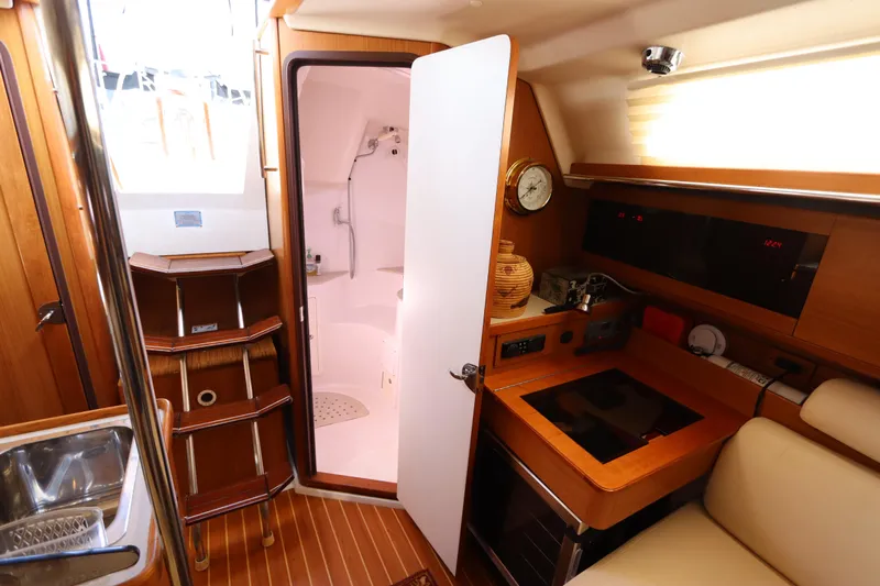  Yacht Photos Pics Interior of 2011 Catalina 355 sailboat with compact kitchen and bathroom.
