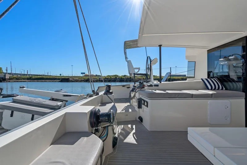 Navitas Yacht Photos Pics 2019 Itacatamarans 14.99 yacht deck with seating, under clear blue sky.