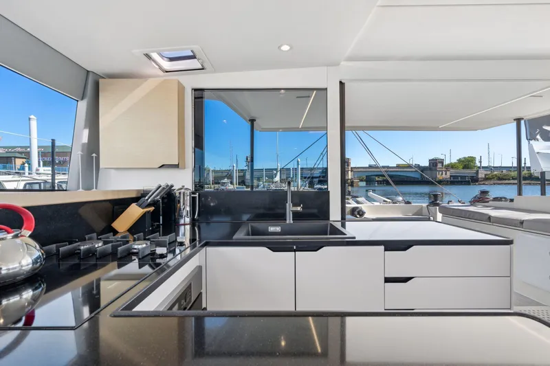 Navitas Yacht Photos Pics Modern kitchen interior on 2019 Itacatamarans 14.99 yacht, featuring sleek design and waterfront view.