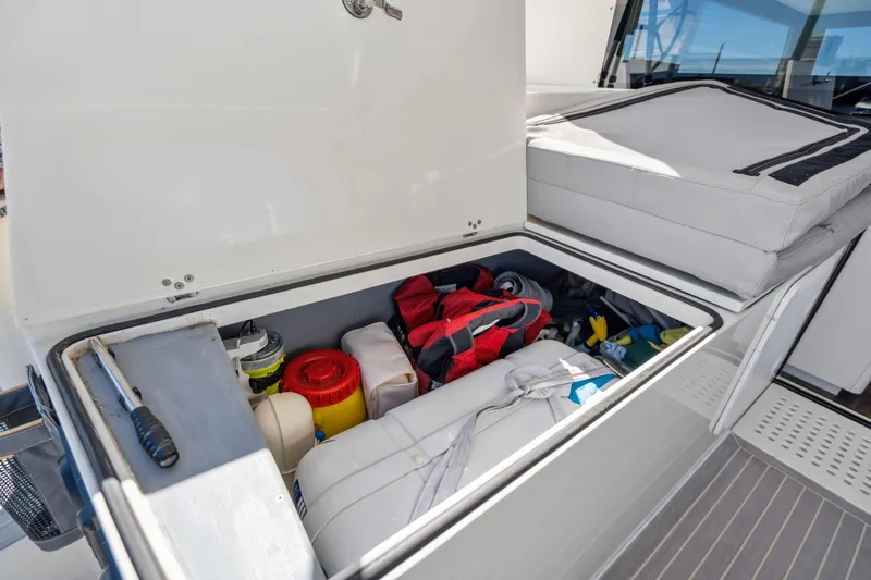 Navitas Yacht Photos Pics Storage compartment on 2019 Itacatamarans 14.99, containing safety gear and equipment.