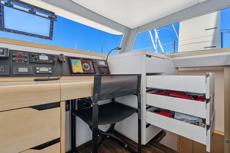 Navitas Yacht Photos Pics 2019 Itacatamarans 14.99 interior with navigation equipment and storage drawers.