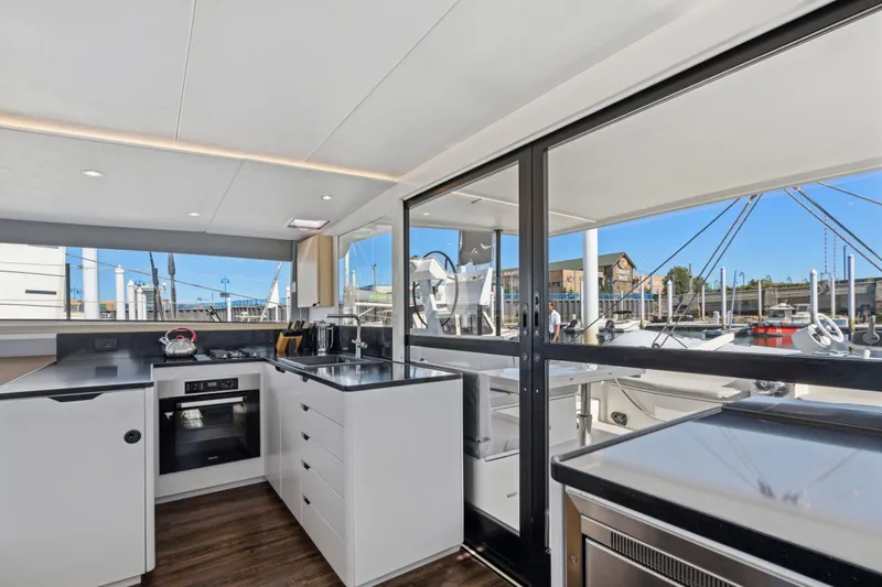 Navitas Yacht Photos Pics Modern kitchen interior on 2019 Itacatamarans 14.99 yacht, featuring sleek design and marina view.
