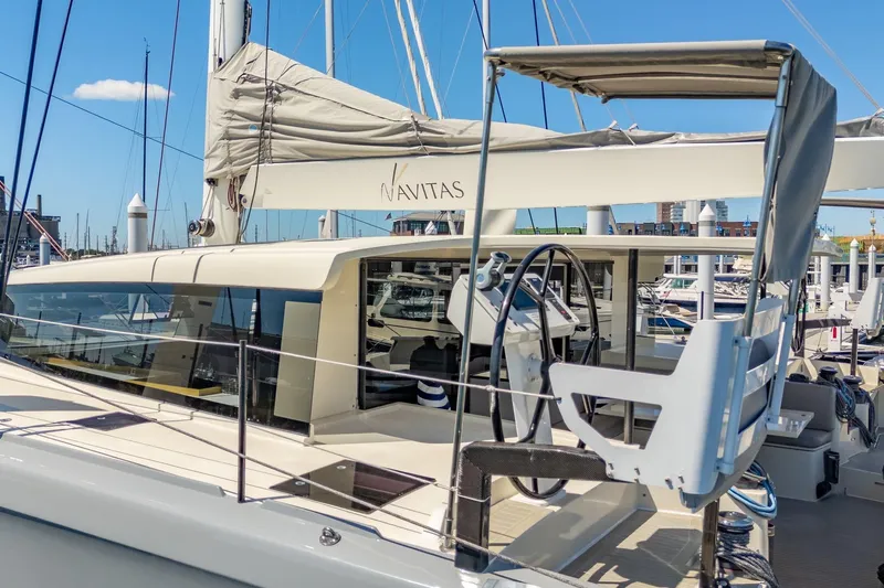 Navitas Yacht Photos Pics 2019 Itacatamarans 14.99 catamaran docked at marina, featuring sleek design and modern helm.