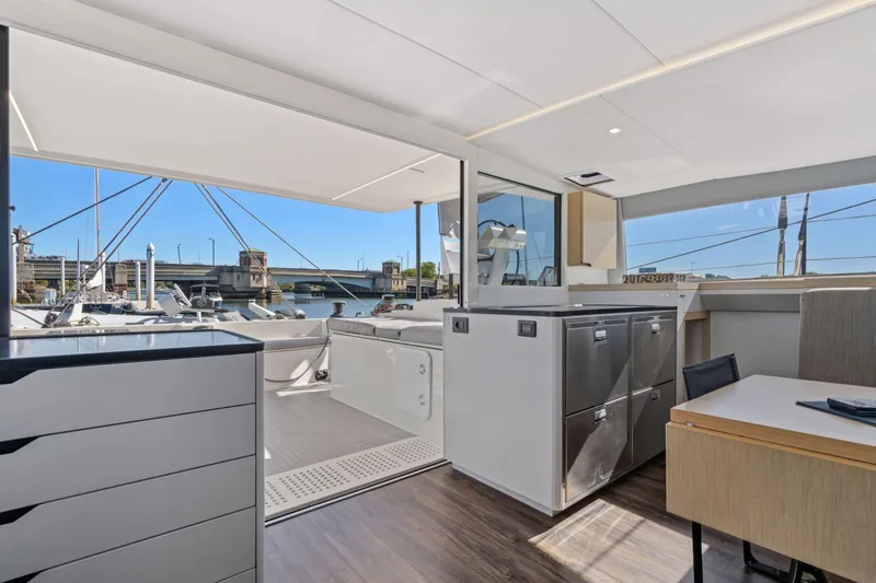 Navitas Yacht Photos Pics Luxurious interior of 2019 Itacatamarans 14.99 yacht with modern design and marina view.