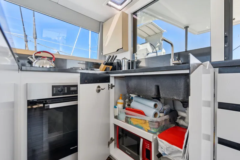 Navitas Yacht Photos Pics Modern kitchen interior of 2019 Itacatamarans 14.99 with appliances and storage.