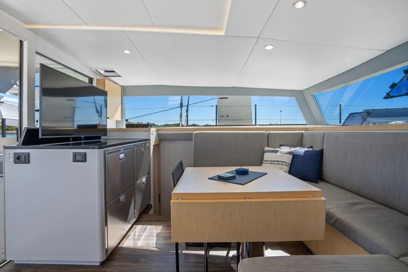 Navitas Yacht Photos Pics Luxurious interior of 2019 Itacatamarans 14.99 with modern seating and entertainment area.