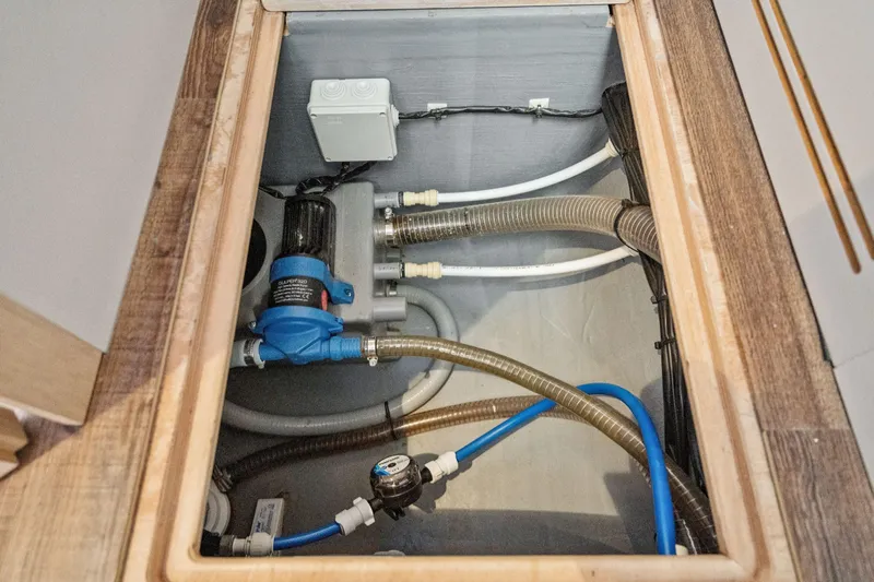 Navitas Yacht Photos Pics Engine compartment of 2019 Itacatamarans 14.99 with visible plumbing and pump system.