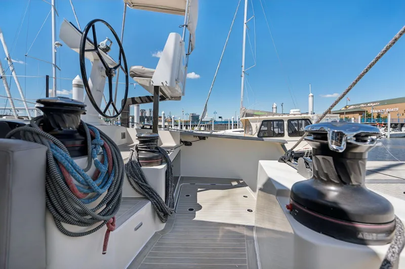 Navitas Yacht Photos Pics 2019 Itacatamarans 14.99 yacht cockpit with steering wheel and ropes, docked at marina.