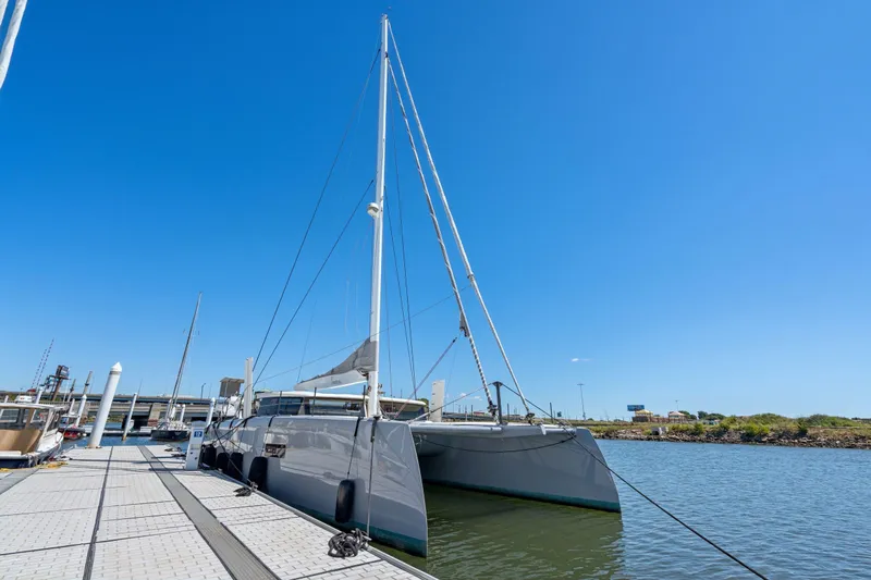 Navitas Yacht Photos Pics 2019 Itacatamarans 14.99 catamaran docked under clear blue sky.