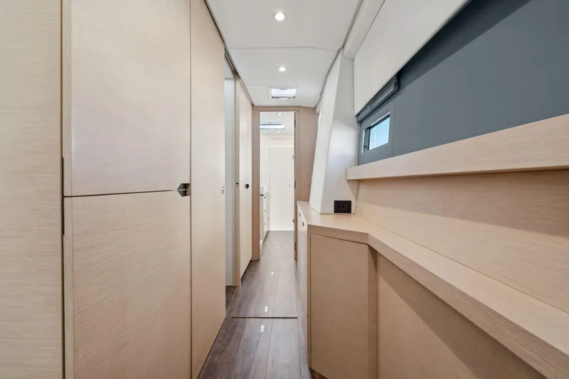 Navitas Yacht Photos Pics Interior hallway of 2019 Itacatamarans 14.99, featuring modern wood paneling and sleek design.