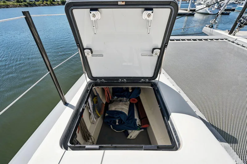Navitas Yacht Photos Pics Open storage hatch on 2019 Itacatamarans 14.99 catamaran, docked by the water.