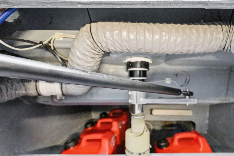 Navitas Yacht Photos Pics Engine compartment of 2019 Itacatamarans 14.99 with hoses and red fuel containers.