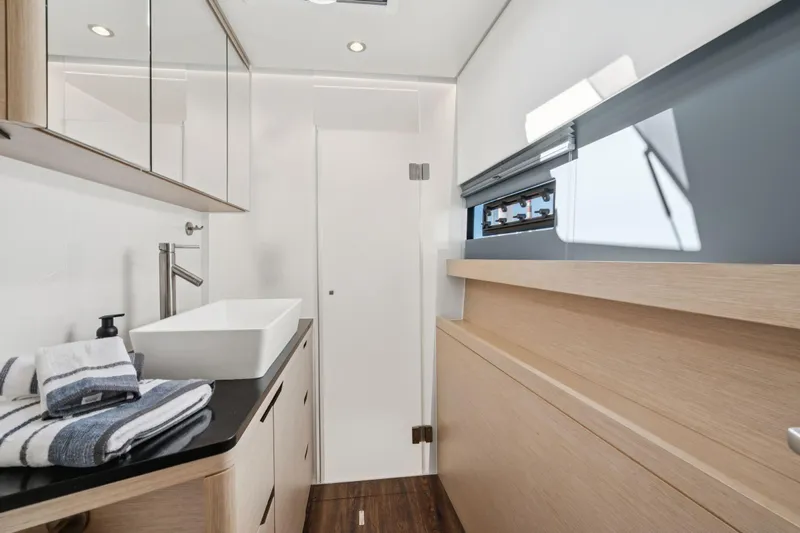 Navitas Yacht Photos Pics Modern bathroom interior on 2019 Itacatamarans 14.99 yacht, featuring sleek design and wooden accents.
