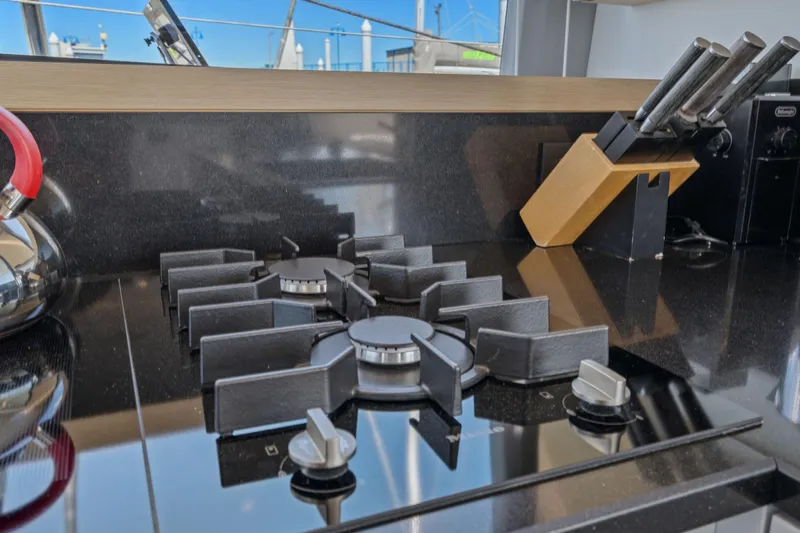Navitas Yacht Photos Pics Modern kitchen on 2019 Itacatamarans 14.99 with sleek black stove and knife set.