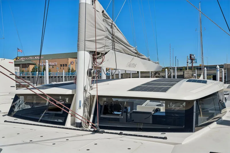 Navitas Yacht Photos Pics 2019 Itacatamarans 14.99 catamaran with solar panels, docked at a marina.