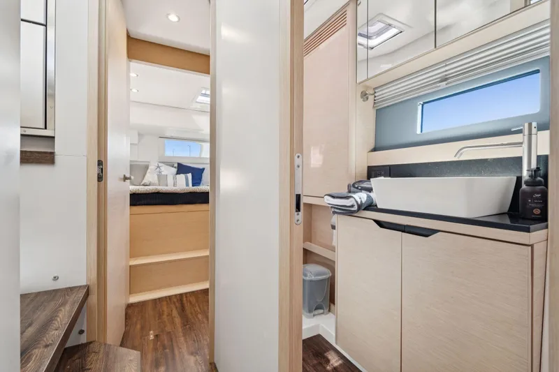 Navitas Yacht Photos Pics Luxurious interior of 2019 Itacatamarans 14.99, featuring modern bathroom and cozy bedroom.