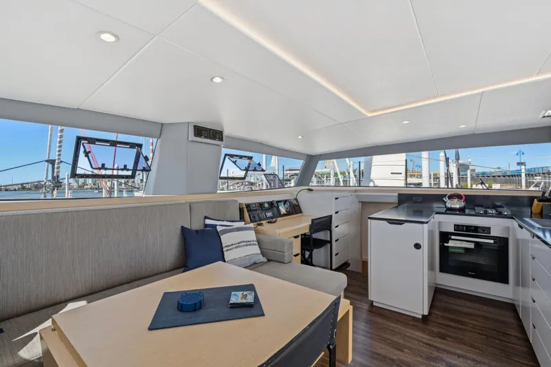 Navitas Yacht Photos Pics Modern interior of 2019 Itacatamarans 14.99, featuring sleek kitchen and seating area.