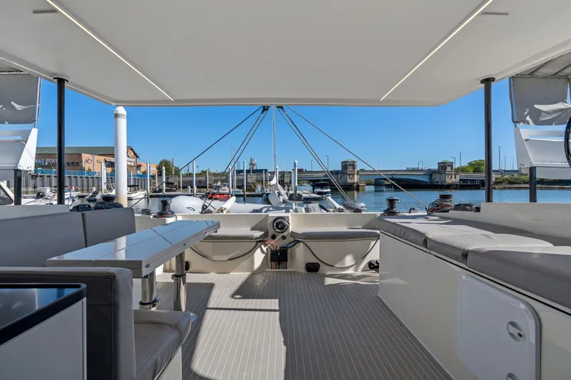 Navitas Yacht Photos Pics Spacious deck of 2019 Itacatamarans 14.99, docked with scenic waterfront view.