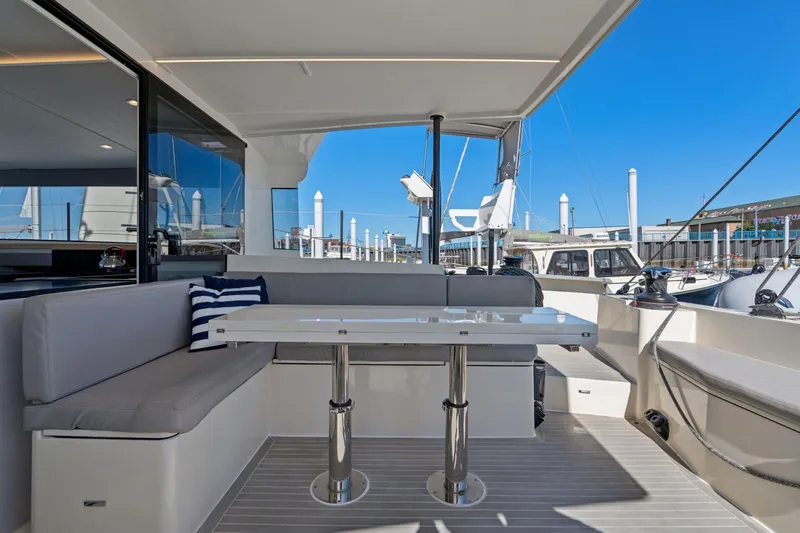 Navitas Yacht Photos Pics Luxurious 2019 Itacatamarans 14.99 yacht interior with elegant seating and table setup.