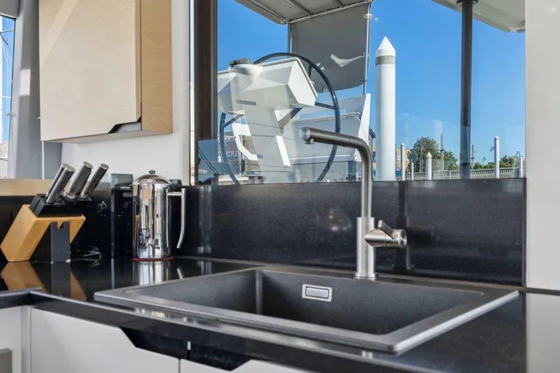 Navitas Yacht Photos Pics Modern kitchen sink on 2019 Itacatamarans 14.99 yacht with sleek black countertop.
