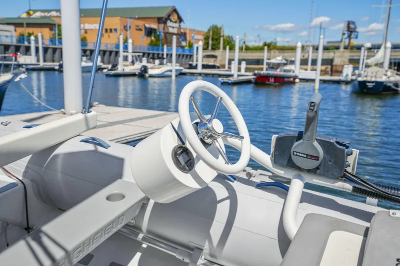 Navitas Yacht Photos Pics Steering wheel of 2019 Itacatamarans 14.99 at marina, sunny day.