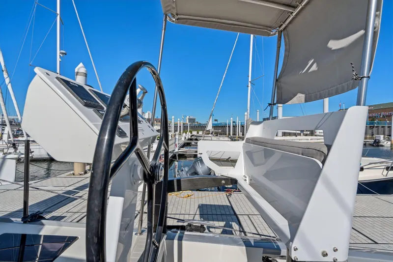 Navitas Yacht Photos Pics 2019 Itacatamarans 14.99 catamaran helm station with marina view.