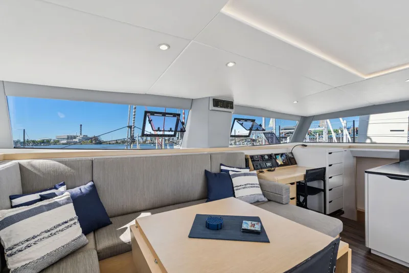 Navitas Yacht Photos Pics Luxurious interior of 2019 Itacatamarans 14.99 with modern seating and navigation area.