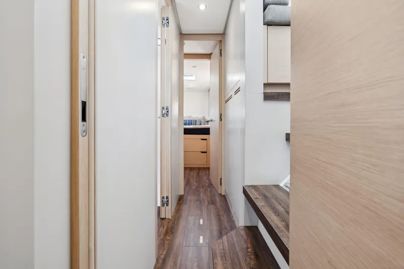Navitas Yacht Photos Pics Hallway interior of 2019 Itacatamarans 14.99, featuring modern wood finishes and sleek design.