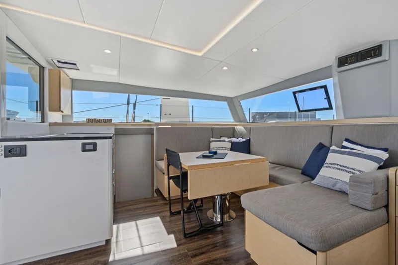 Navitas Yacht Photos Pics Modern interior of 2019 Itacatamarans 14.99 with sleek seating and large windows.