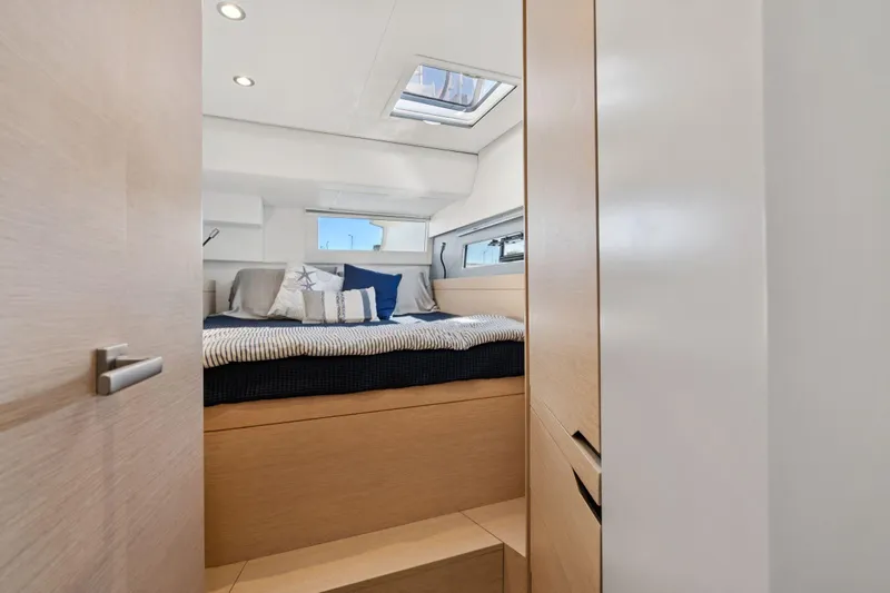 Navitas Yacht Photos Pics Luxurious cabin interior of 2019 Itacatamarans 14.99 with modern bedding and skylight.