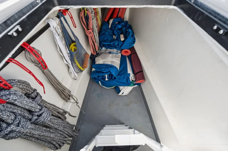 Navitas Yacht Photos Pics Storage compartment on 2019 Itacatamarans 14.99, featuring ropes and equipment.