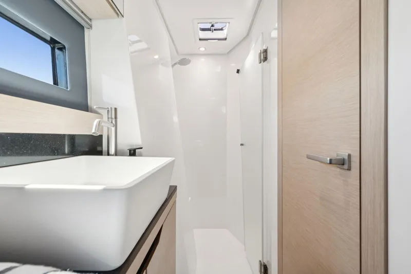 Navitas Yacht Photos Pics Modern bathroom interior on 2019 Itacatamarans 14.99 yacht, featuring sleek sink and minimalist design.