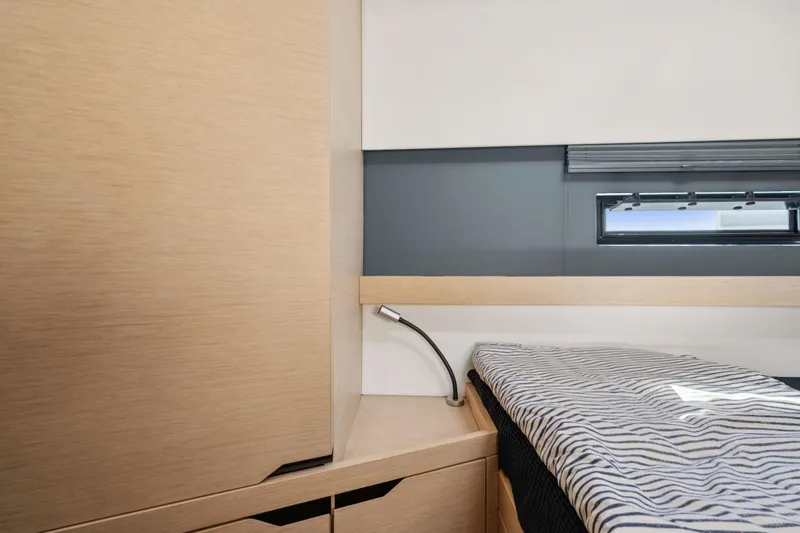 Navitas Yacht Photos Pics Interior cabin of 2019 Itacatamarans 14.99 with modern design and striped bedding.