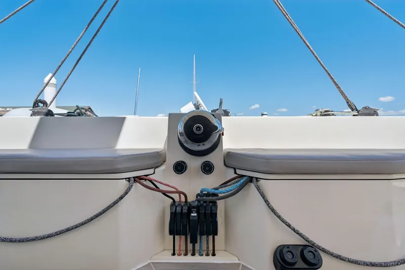 Navitas Yacht Photos Pics 2019 Itacatamarans 14.99 cockpit with steering wheel and ropes under clear blue sky.