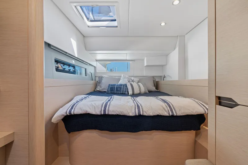 Navitas Yacht Photos Pics Luxurious cabin interior of 2019 Itacatamarans 14.99, featuring a cozy bed and modern design.