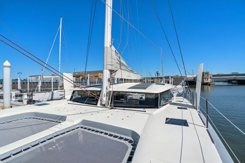 Navitas Yacht Photos Pics 2019 Itacatamarans 14.99 catamaran docked at marina under clear blue sky.