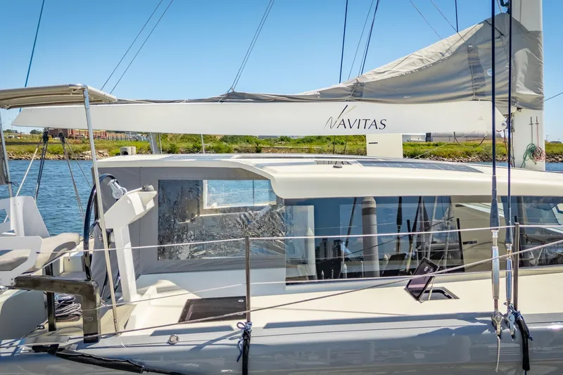 Navitas Yacht Photos Pics 2019 Itacatamarans 14.99 catamaran, docked with sails, featuring sleek design and modern amenities.