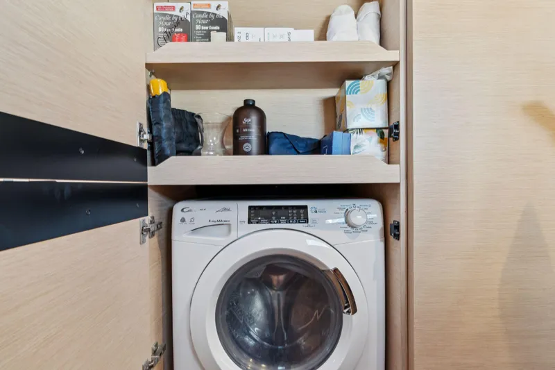 Navitas Yacht Photos Pics Laundry area in 2019 Itacatamarans 14.99 with washing machine and storage shelves.