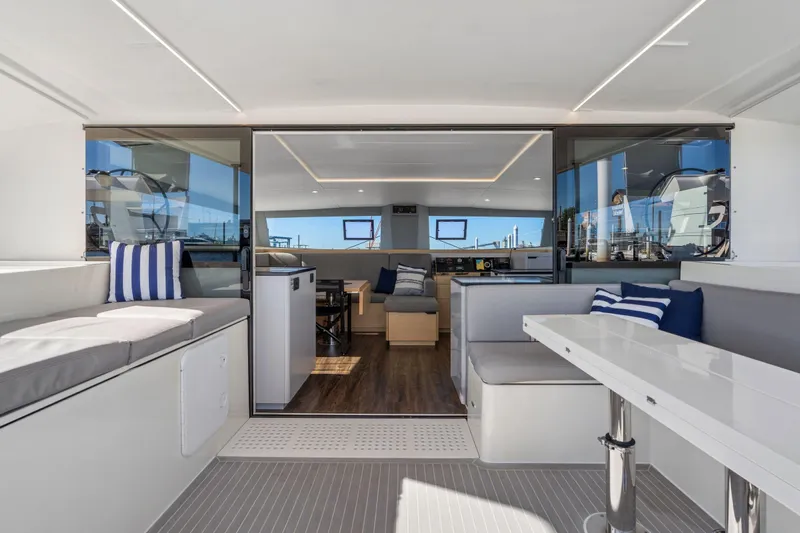 Navitas Yacht Photos Pics Luxurious interior of 2019 Itacatamarans 14.99 catamaran with modern seating and dining area.