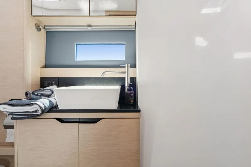 Navitas Yacht Photos Pics Modern bathroom interior of 2019 Itacatamarans 14.99 with sleek sink and window view.